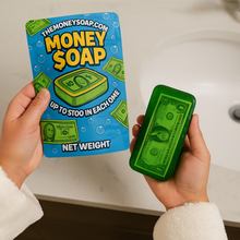 Load image into Gallery viewer, Green soap bar with money design held by hands, next to its packaging labeled &#39;Money Soap&#39;.
