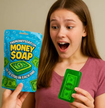 Load image into Gallery viewer, Person holding a package of &#39;Money Soap&#39; and a bar of green soap.
